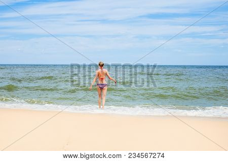 Young Slim Girl Comes Into The Sea.