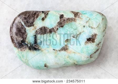 Macro Shooting Of Natural Mineral Rock Specimen - Polished Pegmatite Stone On White Marble Backgroun