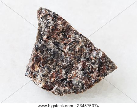 Macro Shooting Of Natural Mineral Rock Specimen - Rough Spreusteined Urtite Stone On White Marble Ba