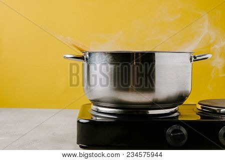 Close-up Shot Of Spaghetti Boiling In Stewpot On Yellow