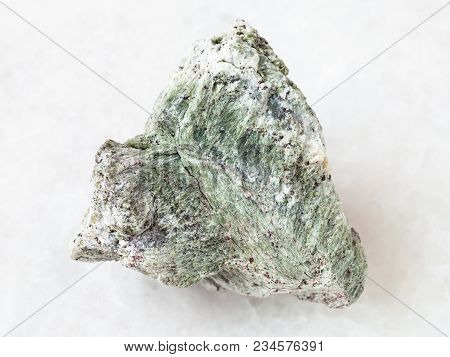 Macro Shooting Of Natural Mineral Rock Specimen - Rough Richterite Stone On White Marble Background 