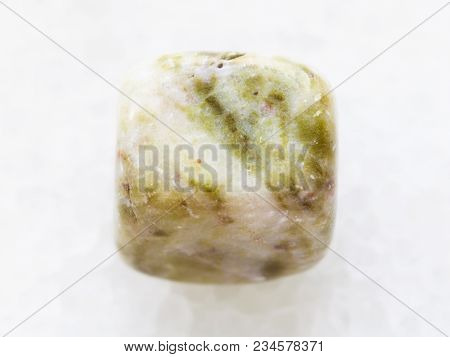 Macro Shooting Of Natural Mineral Rock Specimen - Tumbled Agate Gem Stone On White Marble Background