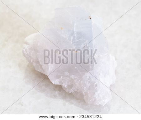 Macro Shooting Of Natural Mineral Rock Specimen - Rough Crystalline Magnesite Stone On White Marble 