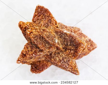 Macro Shooting Of Natural Mineral Rock Specimen - Raw Glendonite Stone On White Marble Background Fr