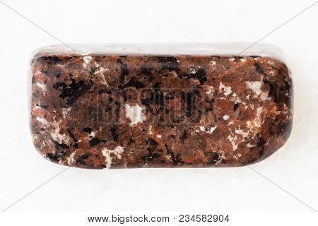 Macro Shooting Of Natural Mineral Rock Specimen - Polished Spreusteined Urtite Stone On White Marble