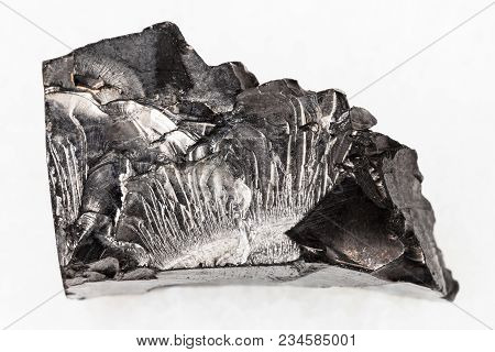 Macro Shooting Of Natural Mineral Rock Specimen - Rough Shungite Stone On White Marble Background Fr