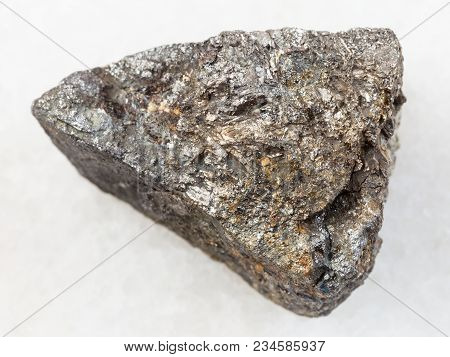 Macro Shooting Of Natural Mineral Rock Specimen - Raw Arsenopyrite Stone On White Marble Background 