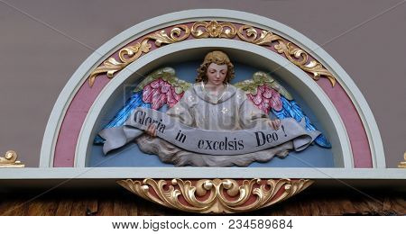 STITAR, CROATIA - NOVEMBER 30: Angel with Gloria in excelsis Deo Banner, Nativity Scene, altarpiece in the church of Saint Matthew in Stitar, Croatia on November 30, 2017.