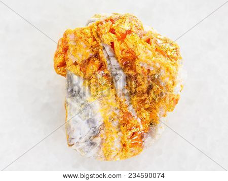 Macro Shooting Of Natural Mineral Rock Specimen - Yellow Orpiment Crystals On White Dolomite Stone O