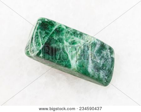 Macro Shooting Of Natural Mineral Rock Specimen - Tumbled Green Jadeite Stone On White Marble Backgr