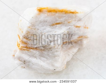 Macro Shooting Of Natural Mineral Rock Specimen - Rough Baryte Ore On White Marble Background From B