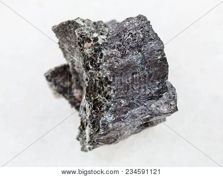 Macro Shooting Of Natural Mineral Rock Specimen - Raw Magnetite Ore On White Marble Background From 