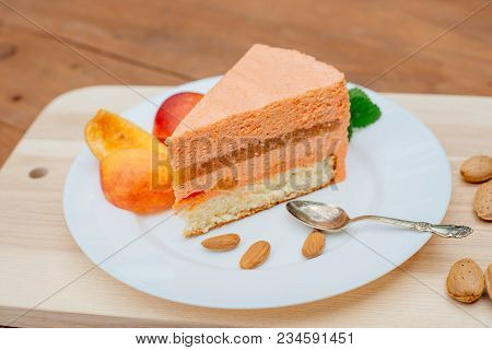 Pie With Peach Souffle. A Piece Of Peach Pie With A Souffle On A Plate.