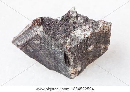 Macro Shooting Of Natural Mineral Rock Specimen - Rough Porphyritic Basalt Stone On White Marble Bac