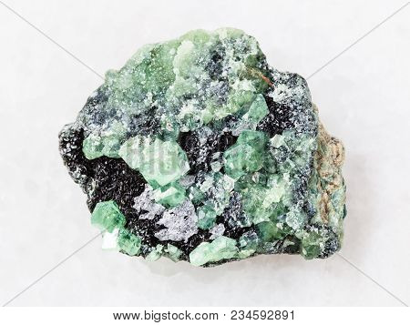 Macro Shooting Of Natural Mineral Rock Specimen - Rough Crystals Of Demantoid Garnet Stone On White 