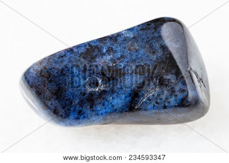 Macro Shooting Of Natural Mineral Rock Specimen - Tumbled Dumortierite Gem On White Marble Backgroun