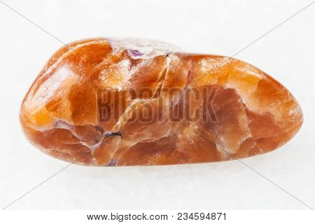 Macro Shooting Of Natural Mineral Rock Specimen - Polished Tinaksite Gemstone On White Marble Backgr