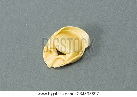 A Tortellino Pasta On A Gray Surface