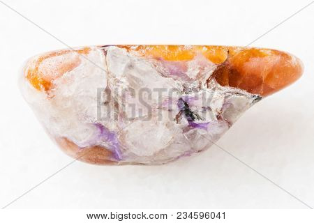 Macro Shooting Of Natural Mineral Rock Specimen - Charoite In Tumbled Tinaksite Gemstone On White Ma