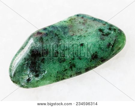 Macro Shooting Of Natural Mineral Rock Specimen - Polished Zoisite Gemstone On White Marble Backgrou