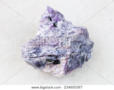 Macro Shooting Of Natural Mineral Rock Specimen - Rough Charoite Stone On White Marble Background Fr