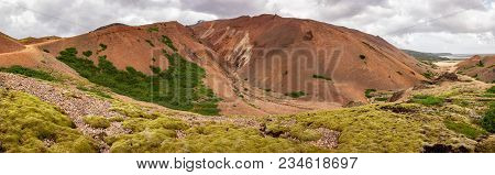 Wide Angle Panorama Of Red Mountains Of Lonsoraefi In Iceland, Europe  In Overcast Weather