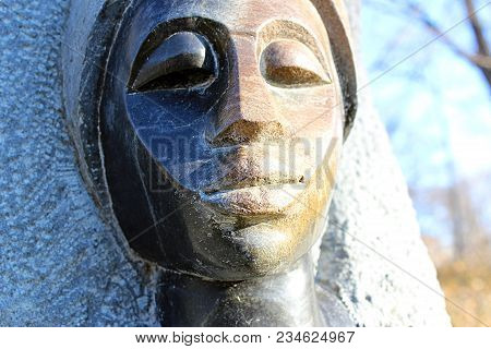 Stone African Statue At Sunset With Shadow