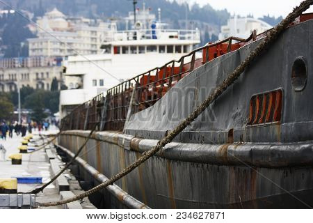 Old Rusty Cargo Ship Moored At Civil Port. . Aged Vessel Recycling Necessity Concept.