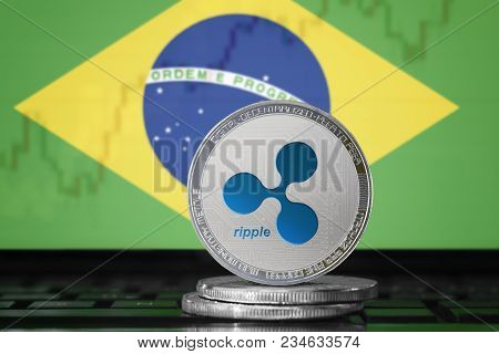 Ripple (xrp) Cryptocurrency; Physical Concept Ripple Coin On The Background Of The Flag Of Brazil