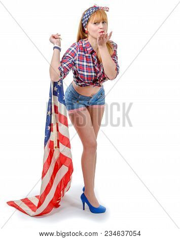 Sexy Pin Up Girl  Holding An American Flag Isolated On The White Background