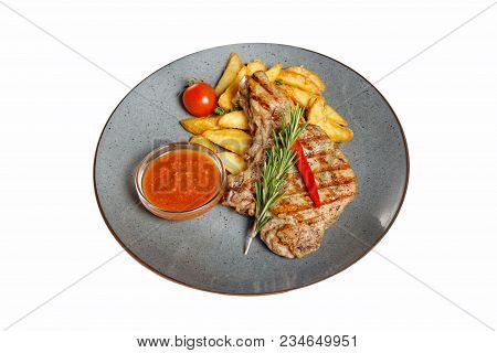Fried Meat With Garnish Of Pepper, Zucchini, Tomato And Corn With Ajika Sauce Served On A Gray Plate