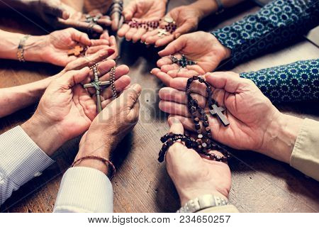 Closeup of diverse palms with cross necklets christianity believe