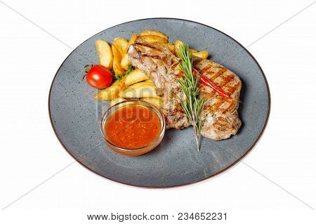 Fried Meat With Garnish Of Pepper, Zucchini, Tomato And Corn With Ajika Sauce Served On A Gray Plate