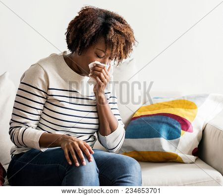 Woamn sick at home on the couch
