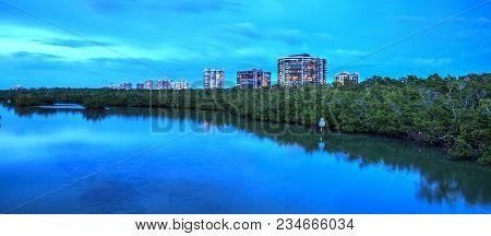 Dusk Falls Over The Clam Pass River Way Leading To The Ocean In Naples, Florida