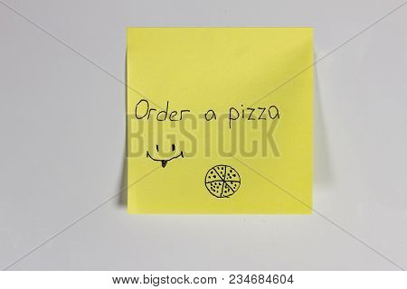 Yellow Sticker On The Door Of The Refrigerator With The Inscription Pizza