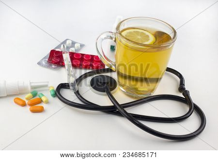Tea With Lemon, Thermometer, Tablets On White Background