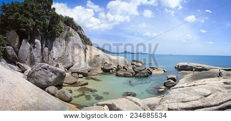 Tourists Exploring The Rocksy Coastline And Clear Sea Pools Near The Grandfather Rock On Lamai Beach
