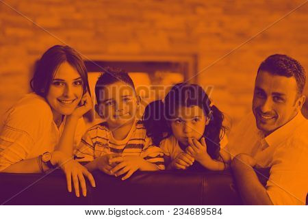 happy young family relax and have fun at modern home indooor duo tone