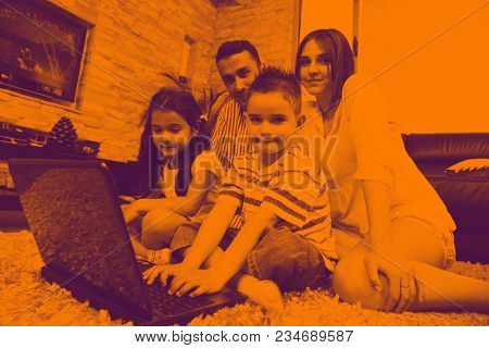 happy young family relax and have fun at modern home indooor duo tone