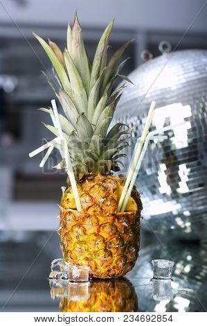 Pineaple Cocktail With Ice On A Glass Table