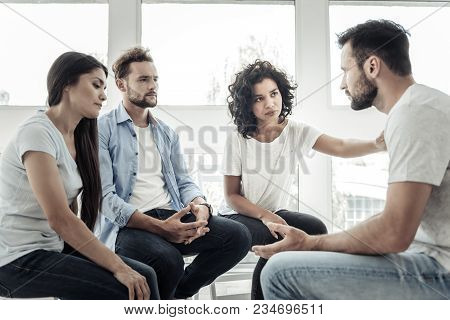 Group Support. Nice Smart Pleasant People Sitting Together And Listening To Their Friend While Expre