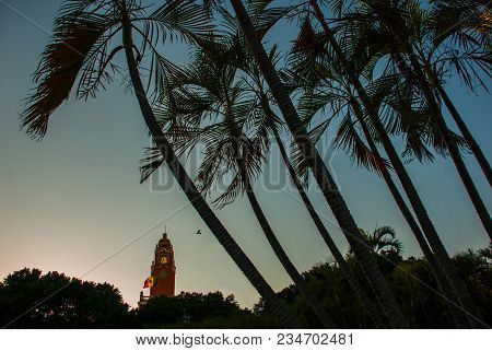 Beautiful Colonial City Of Merida. Red Brick Building Tower With Golden Dome And Clock In The City C