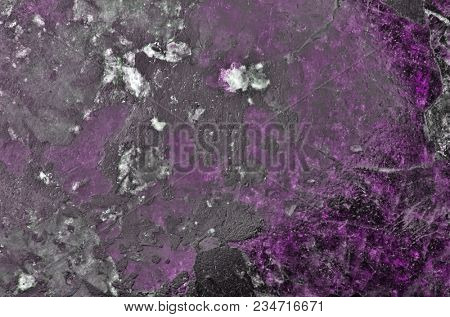 violet and black eudialyte mineral texture macro