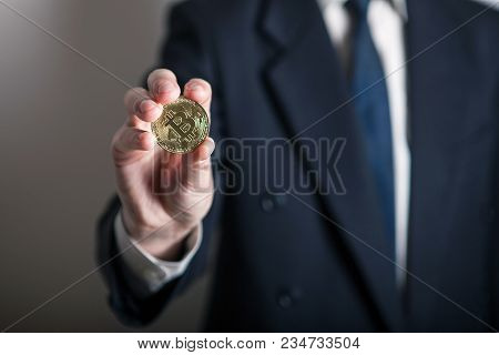 Golden Bitcoin In A Man Hand, Digitall Symbol Of A New Virtual Currency. Man Recived Money From Bitc