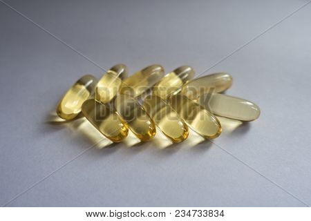 Amber Capsules Of Fish Oil In A Shape Of Spike