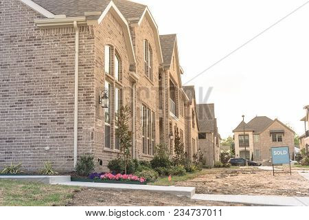 Row Of Newly Built Detached Single-family Homes And Sold Out Sign. Medium Size Multiple Lot Properti