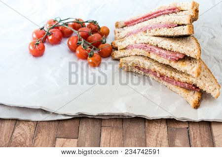 Wholemeal bread sandwich topped with Lyon rosette and butter