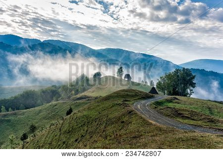 Beautiful Mountain Landscape Of A Foggy Morning With And Old House, Trees And Clouds, Dumesti, Salci