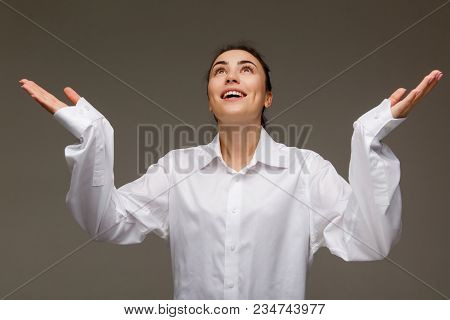 Beautiful Girl In A White Shirt Shows Emotions. On A Light Background.